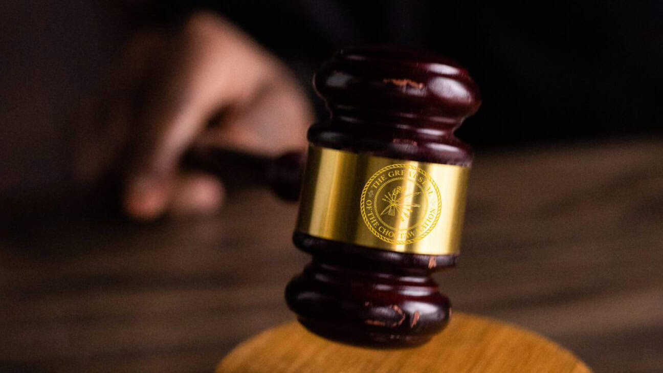 A gavel with the Choctaw Nation Seal hitting the desk.